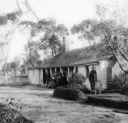 Blue Mountains: Group of four people outside weatherboard cottage.